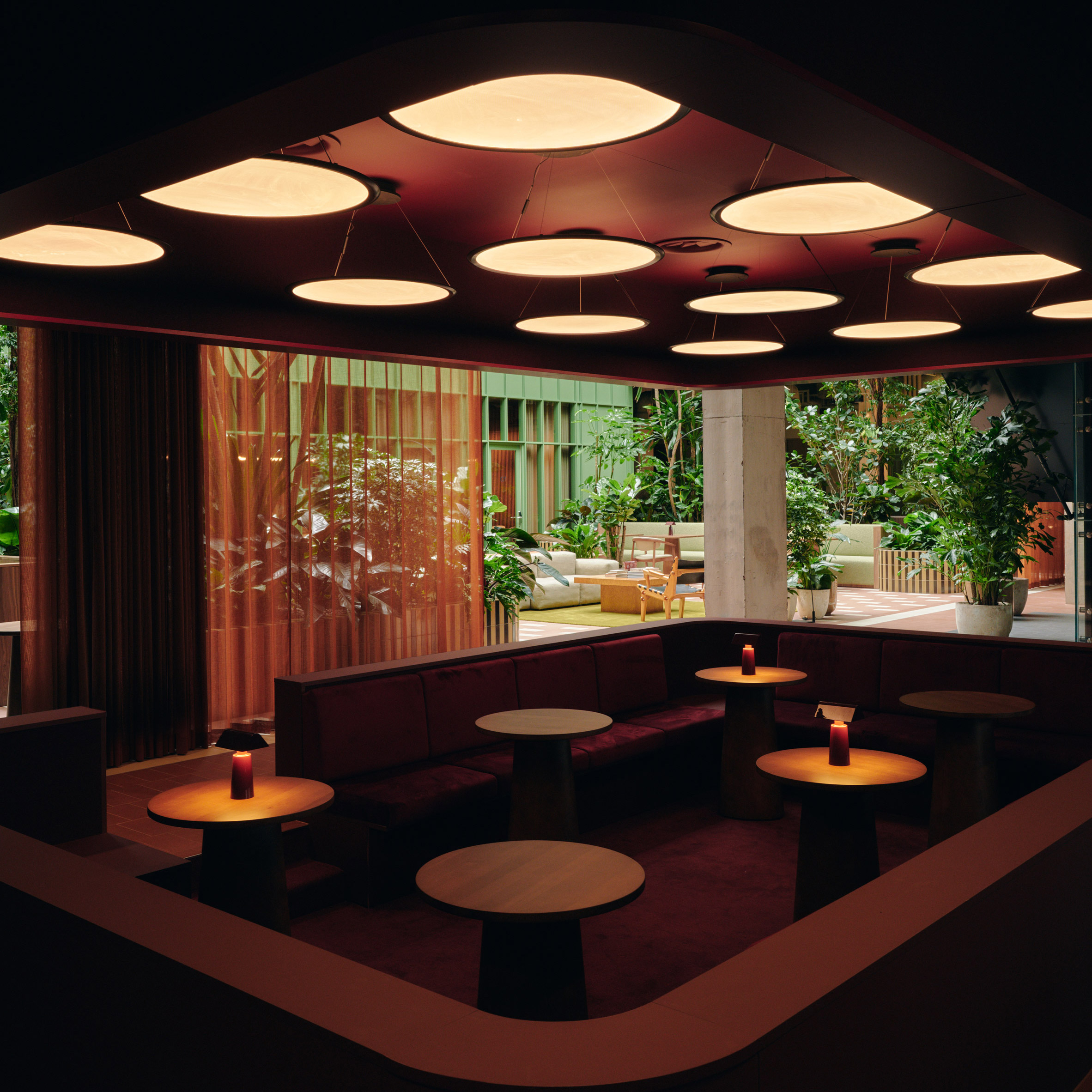 Interior view of the Conductor co-working space at Coppermaker Square, showcasing integrated planting and tactile materials.