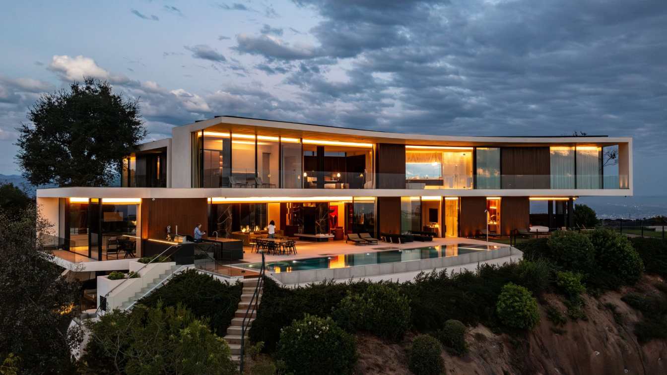 The Briarcrest Residence in Beverly Hills, showcasing its contemporary design, expansive glass facades, and integration with the surrounding landscape.