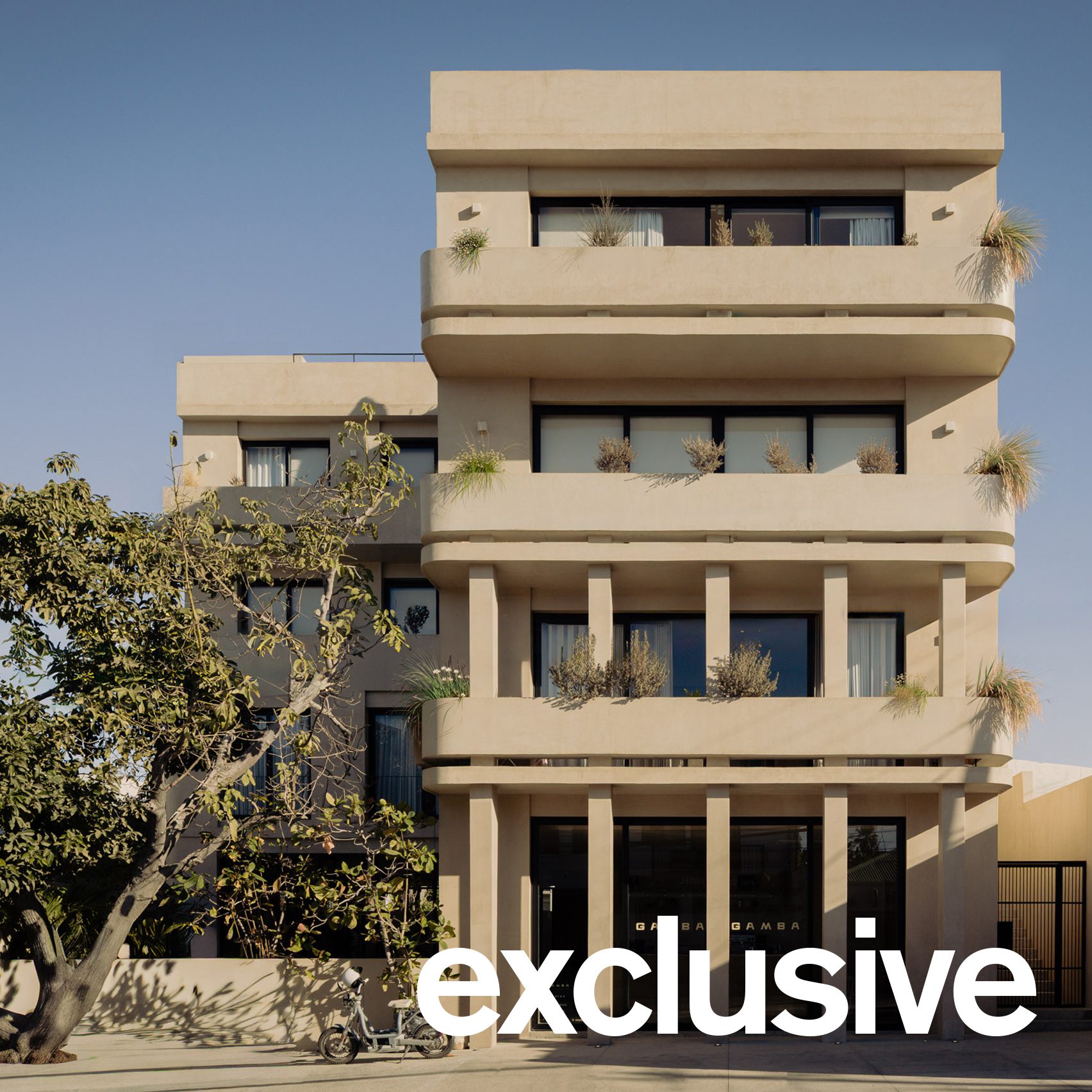 Exterior view of the Estero Residences and Gamba Cafe, showcasing its sculptural volumes, horizontal lines, and rounded balconies.