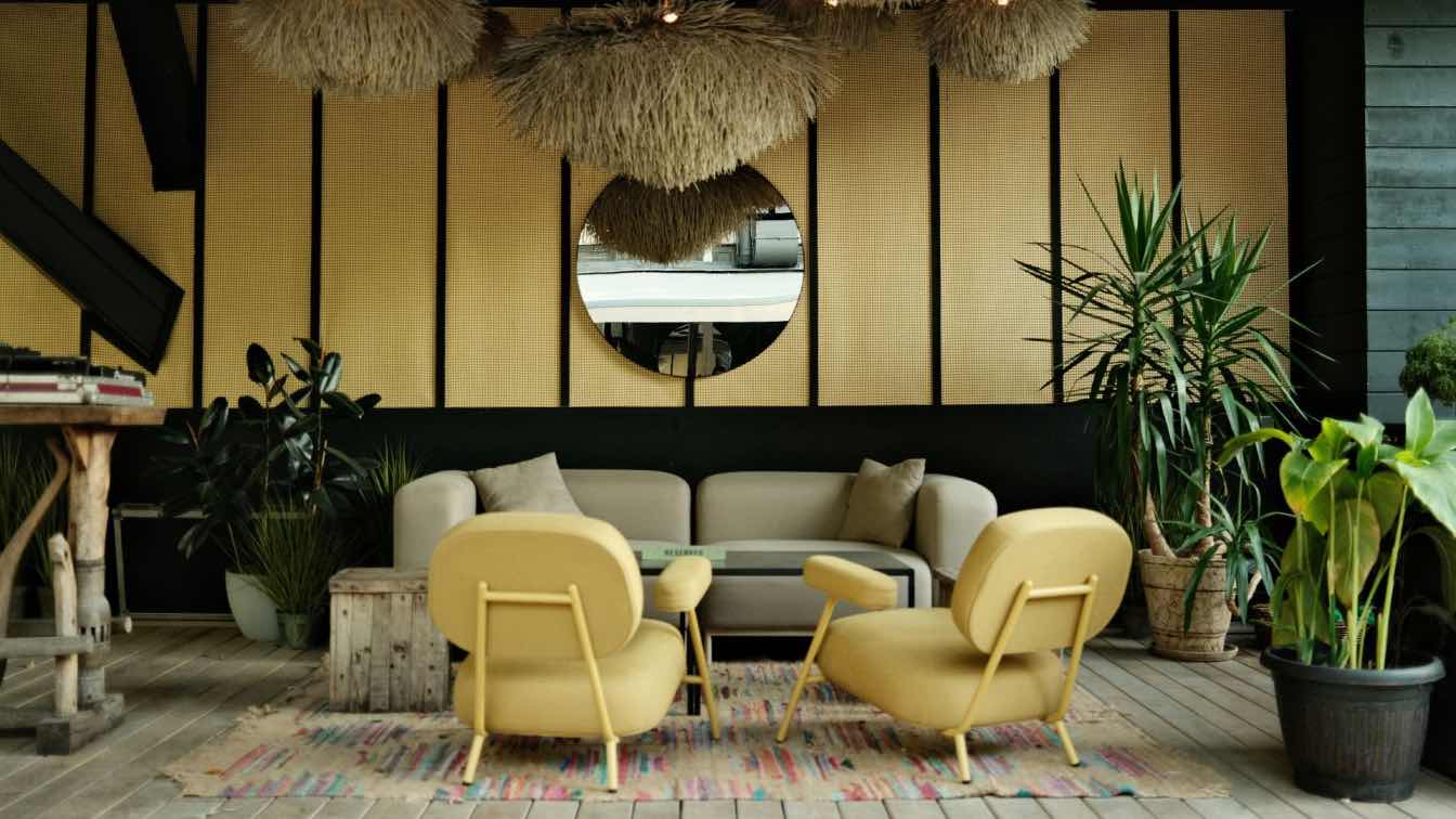 A contemporary living room interior showcasing well-chosen furniture and decorative elements, bathed in natural light.