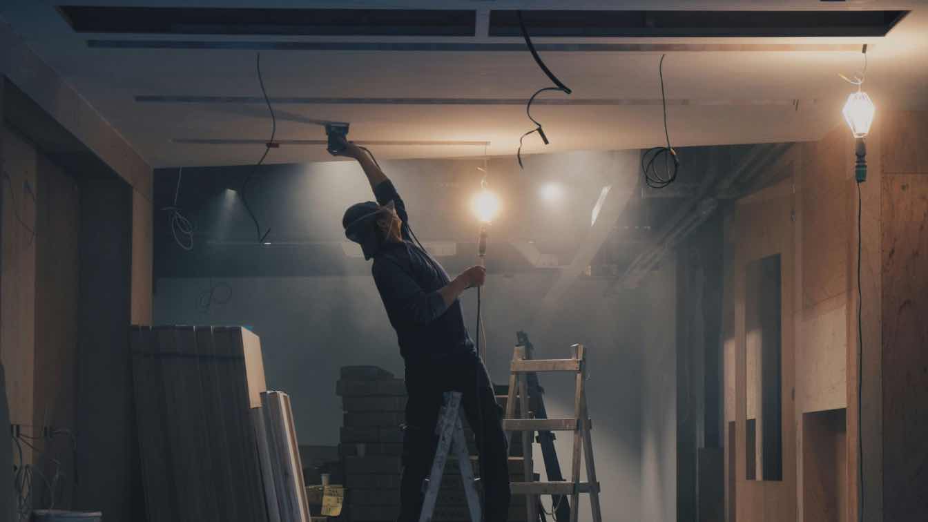 Furniture and boxes are packed into a self-storage unit during a home renovation to protect them from dust and damage.