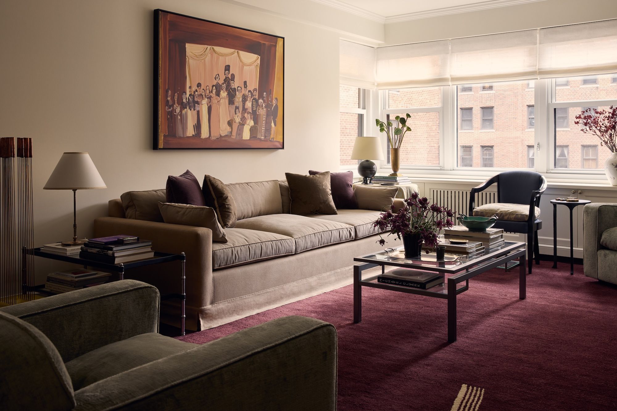 Interior view of a living space in a New York City apartment, showcasing a sofa, coffee table, and artwork on the wall.