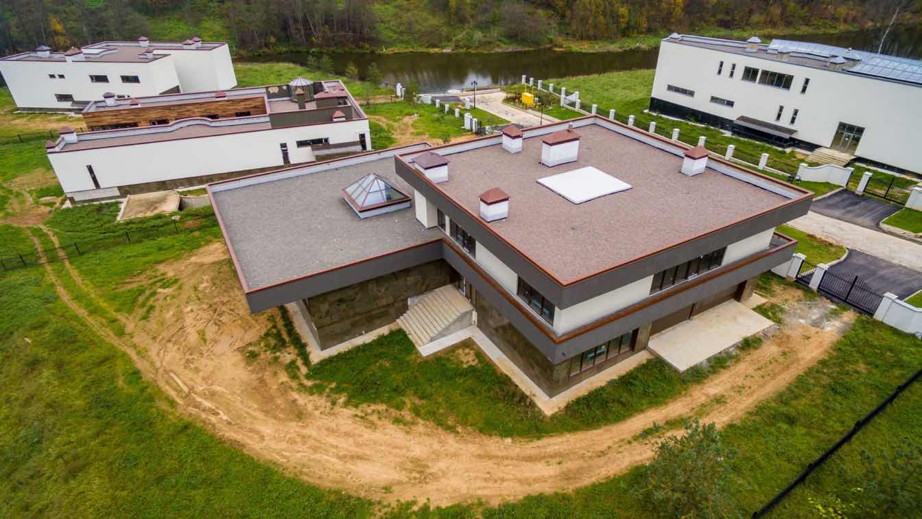 A modern commercial building showcasing a flat roof system.