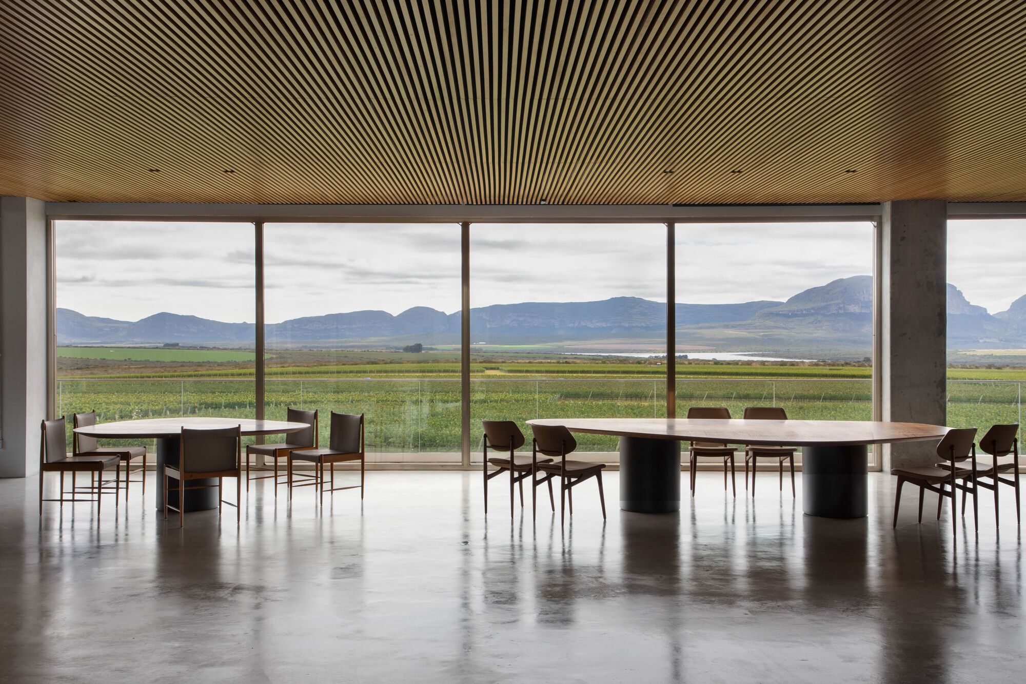 Exterior view of the UVVA Winery showcasing its concrete and wood structure integrated with the natural landscape