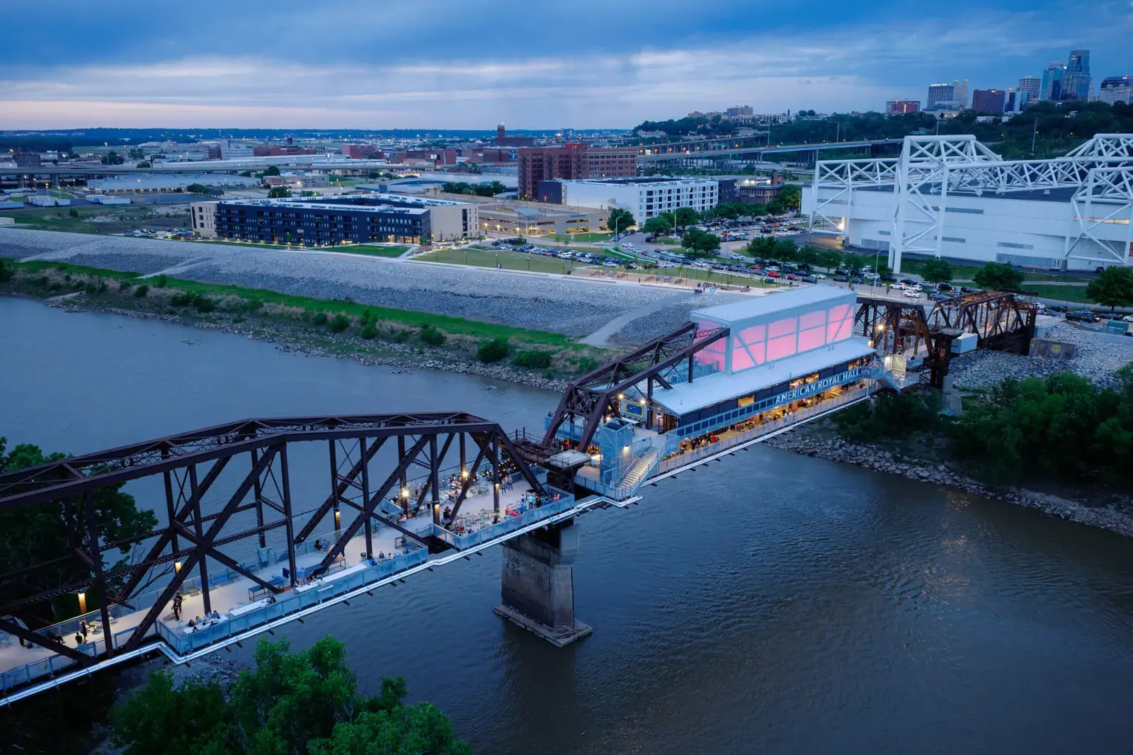 The Rock Island Bridge, now an entertainment district, spans the Kansas River, featuring a translucent event hall and dining areas.