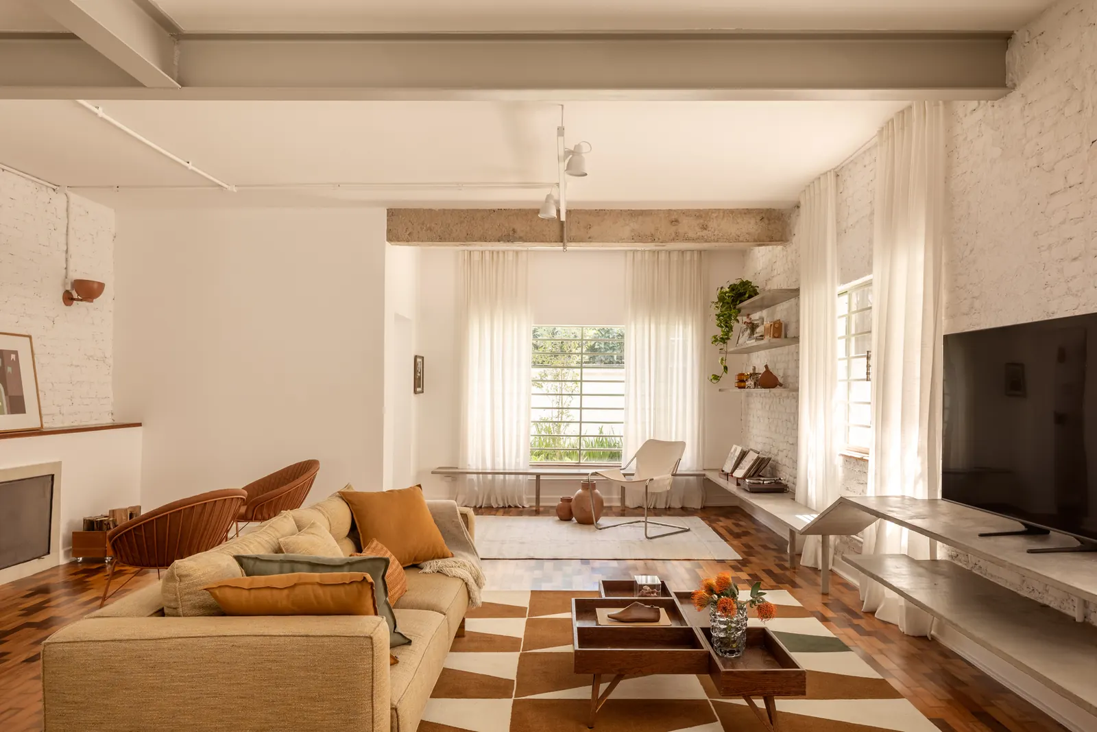 The living area of the Limoeiro House, featuring a restored staircase and open-plan layout bathed in natural light.