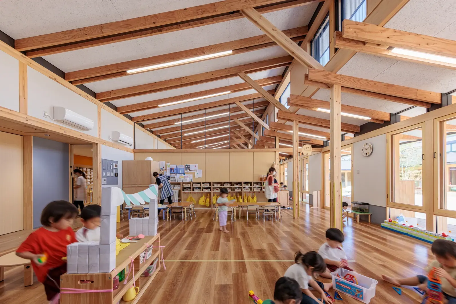 Exterior view of the Kurashiki Central Hospital Miwa Nursery School, featuring prominent orange roof tiles and horizontal architectural lines.
