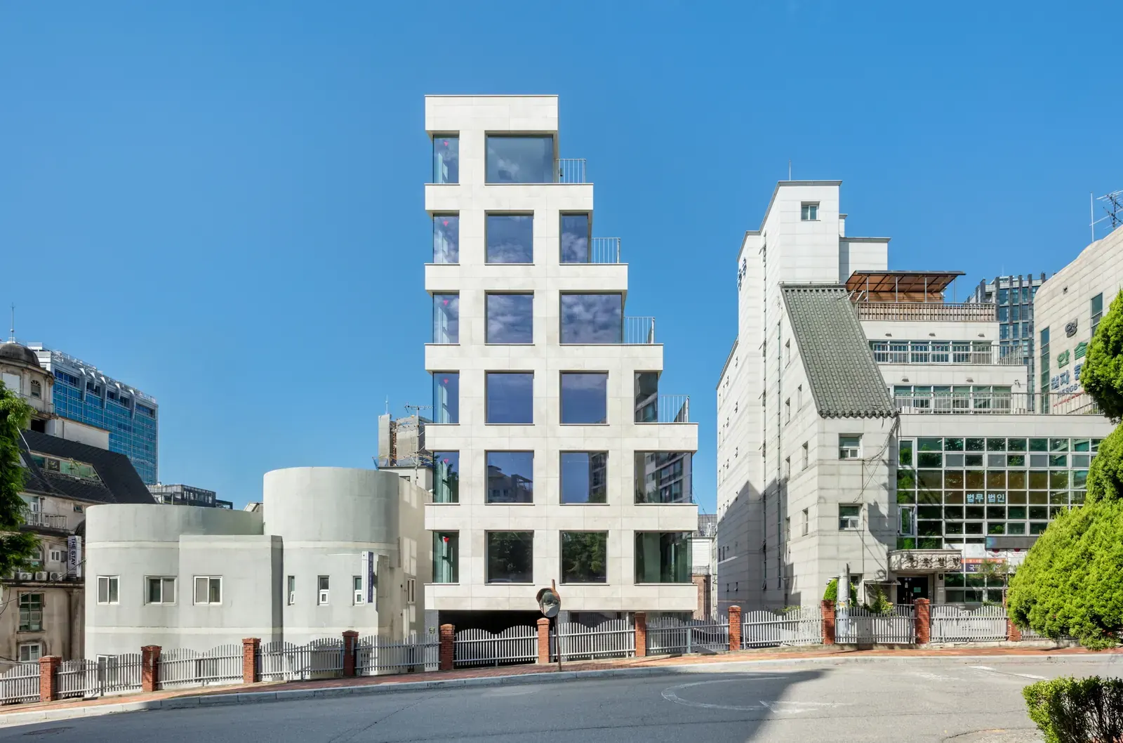 Exterior view of the YP Building in Seoul, showcasing its facade and integration with the urban streetscape.