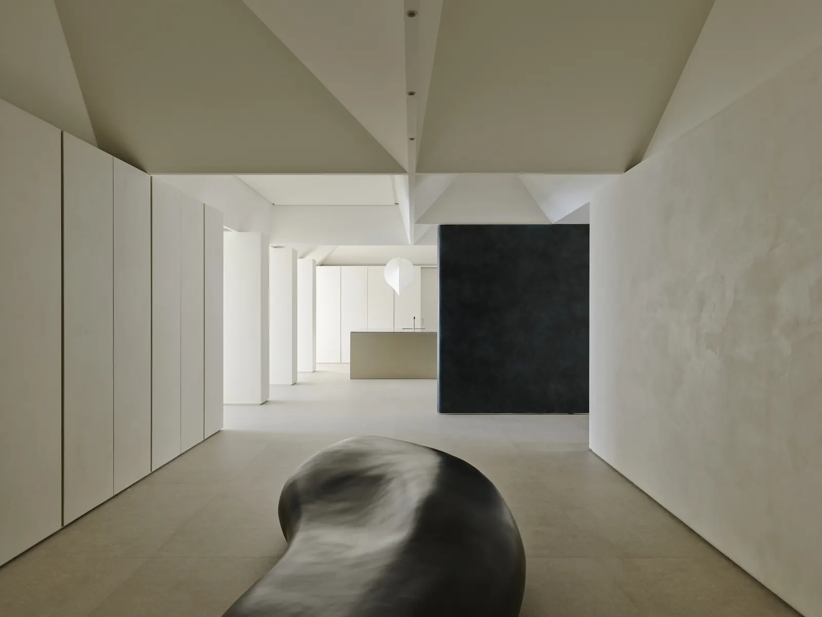Interior of the Curio Residence, featuring a seating area bathed in natural light with contemporary furnishings.