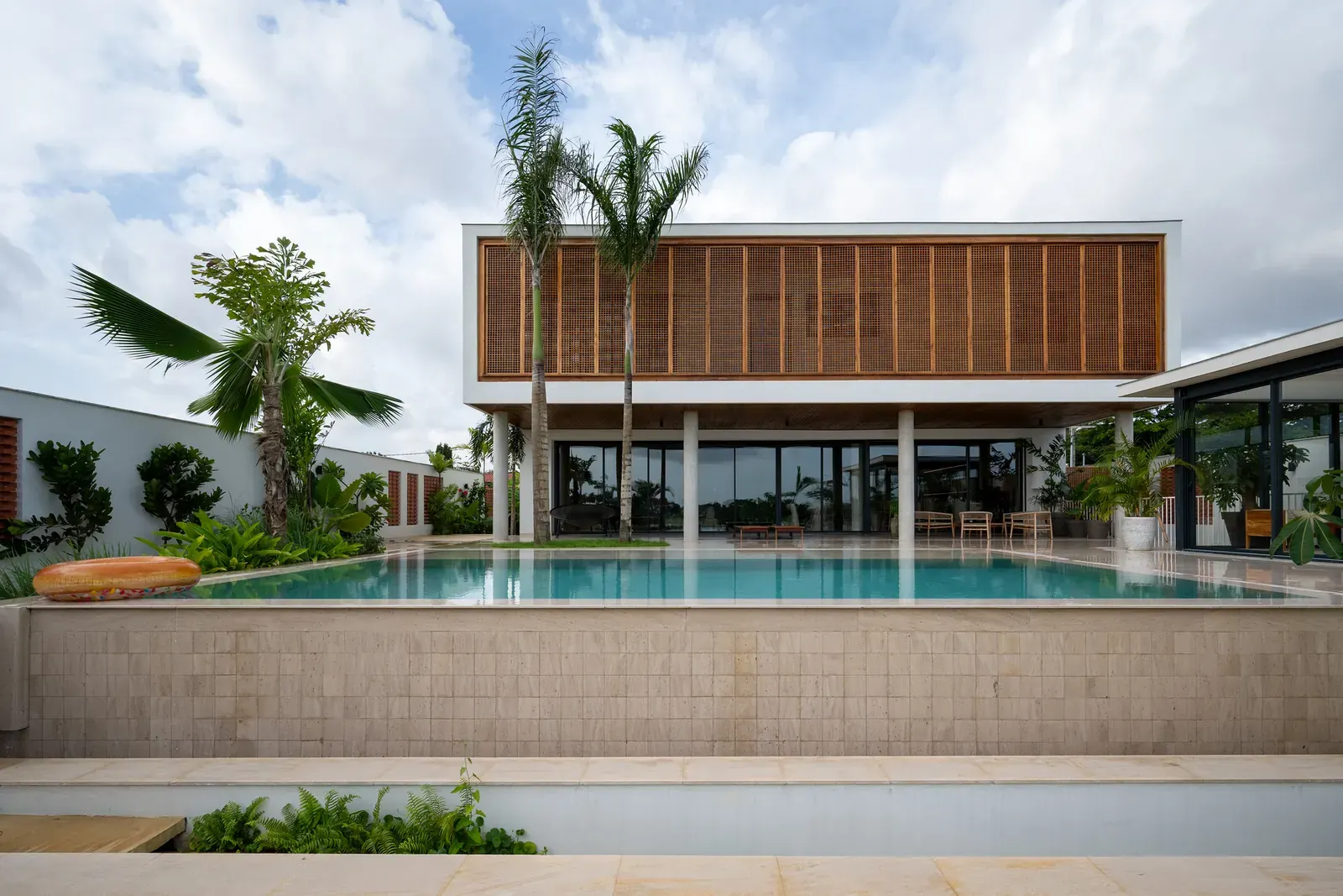 Exterior view of the Villa Riviera Golf Residence, showcasing its compact volume and integration with the sloped site.