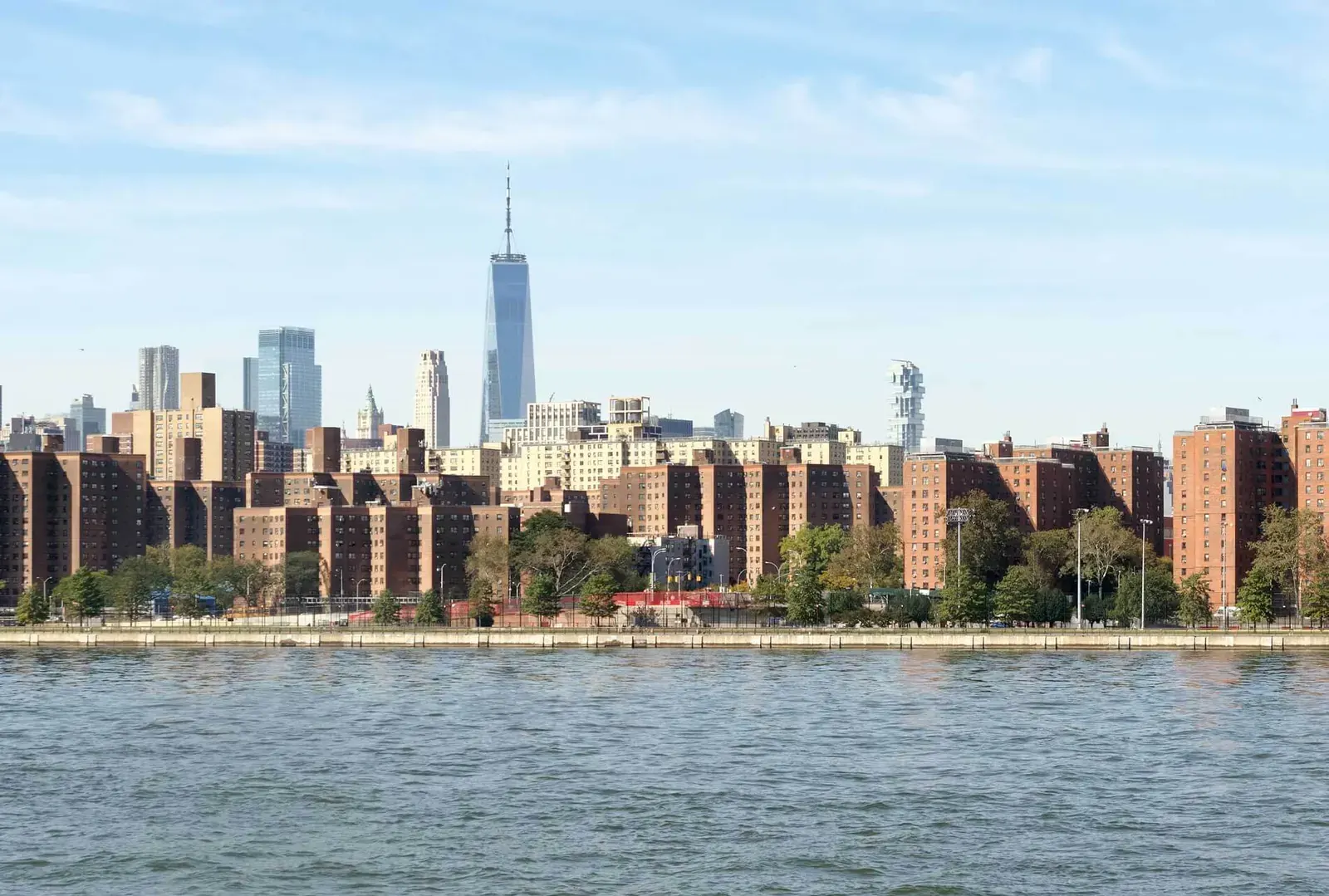 Diverse New York City housing stock under a developing sky, symbolizing the evolving housing policy landscape.
