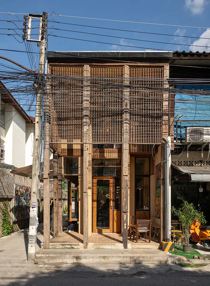 Exterior view of Northgate Spirit, a contemporary building in Chiang Mai featuring a garden and outdoor seating area.