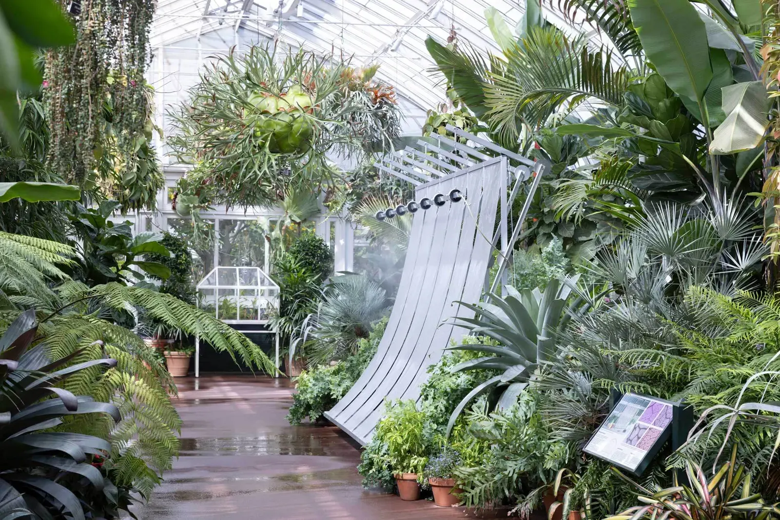 Greenhouse Prototype 2, a climate device installation by Hermine Demaël and Stephen Zimmerer, displayed within the glass dome of the New York Botanical Garden's Enid A. Haupt