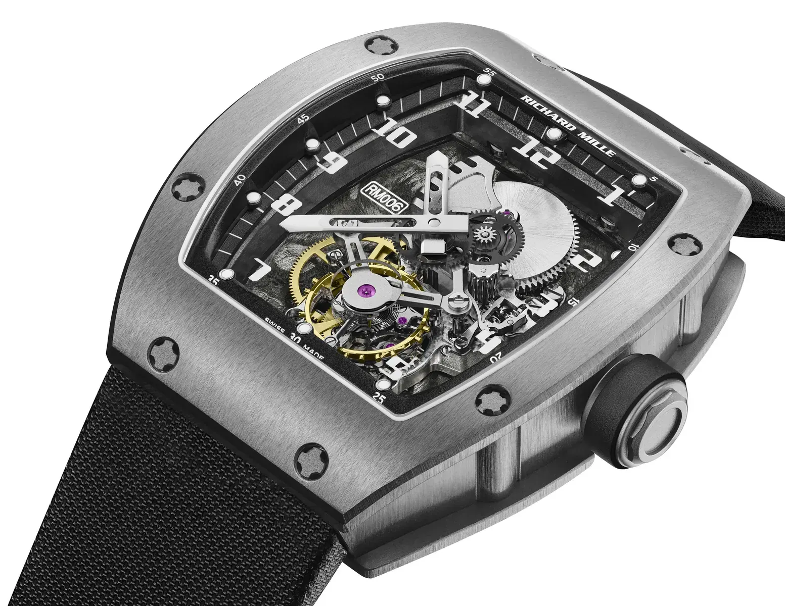 A close-up view of the Richard Mille RM 001 Tourbillon prototype watch, showcasing its intricate open-worked movement and tonneau-shaped case.