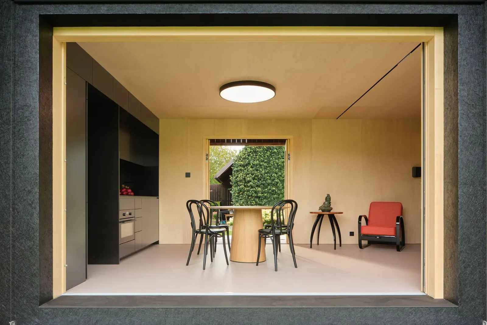 Interior view of a contemporary home built inside a barn, featuring natural wood finishes and minimalist design.