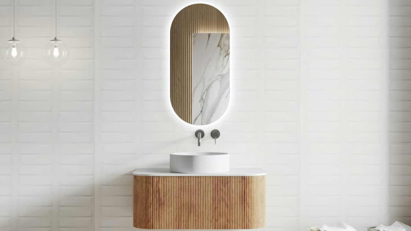 A well-lit modern bathroom featuring a stylish and functional vanity unit.