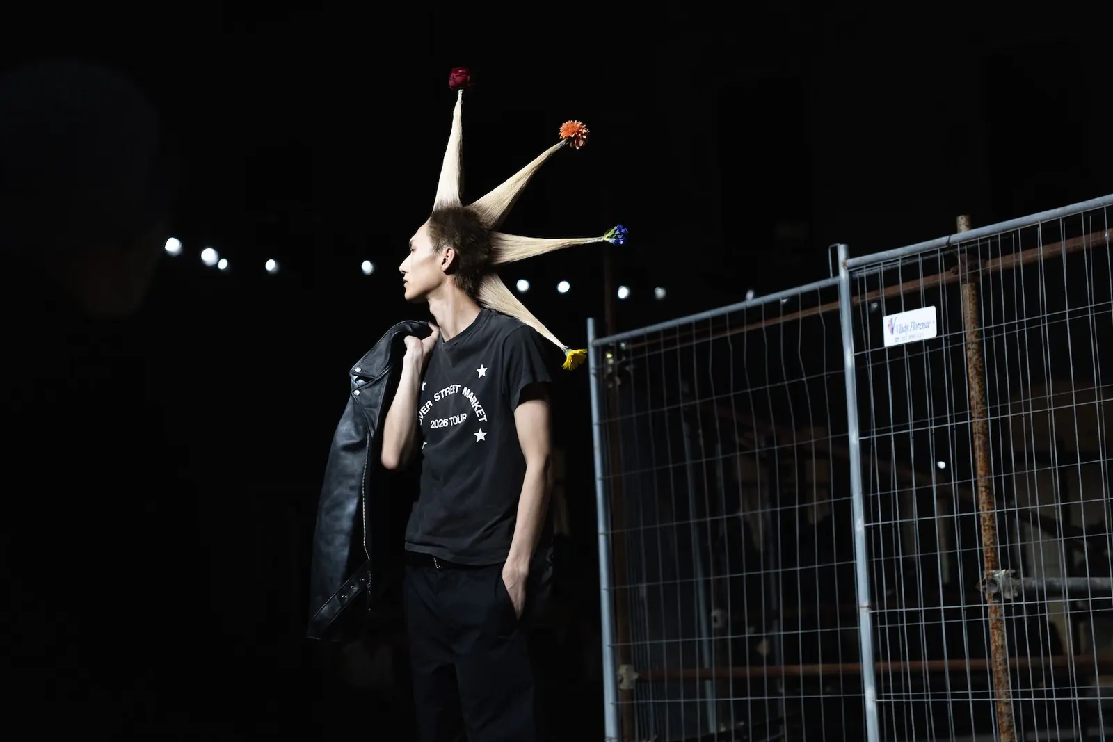 Models showcase looks from DSM Kei Ninomiya's Spring/Summer 2027 collection at Pitti Uomo, featuring punk-inspired styling with floral accents.