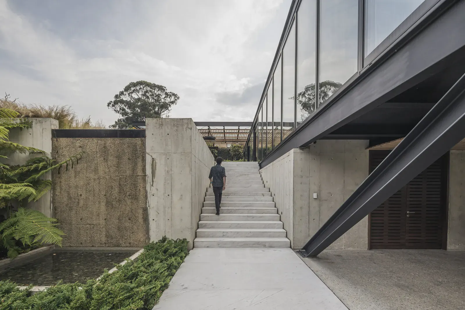 Exterior view of the Steel House, showcasing its modern design with steel components and integration into a natural landscape.