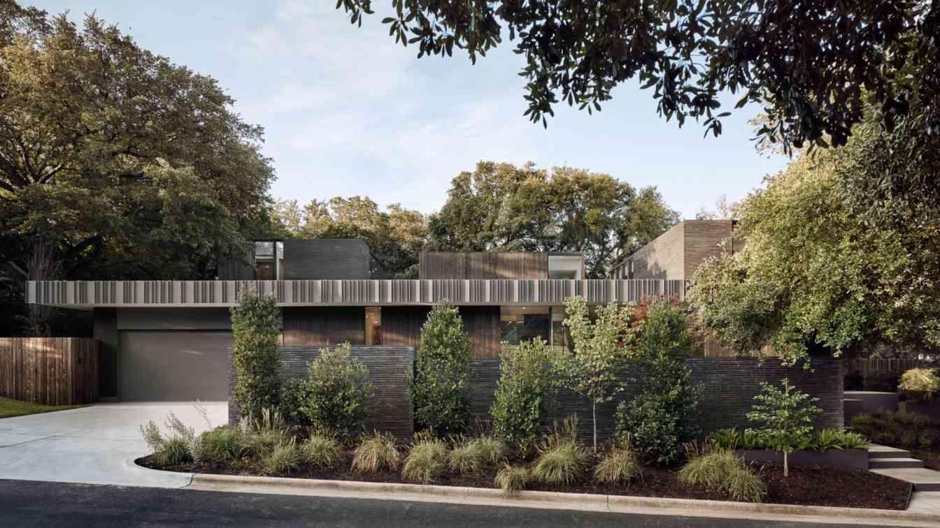 Exterior view of the Tarrytown Residence showcasing its modern design and integration with the surrounding landscape.