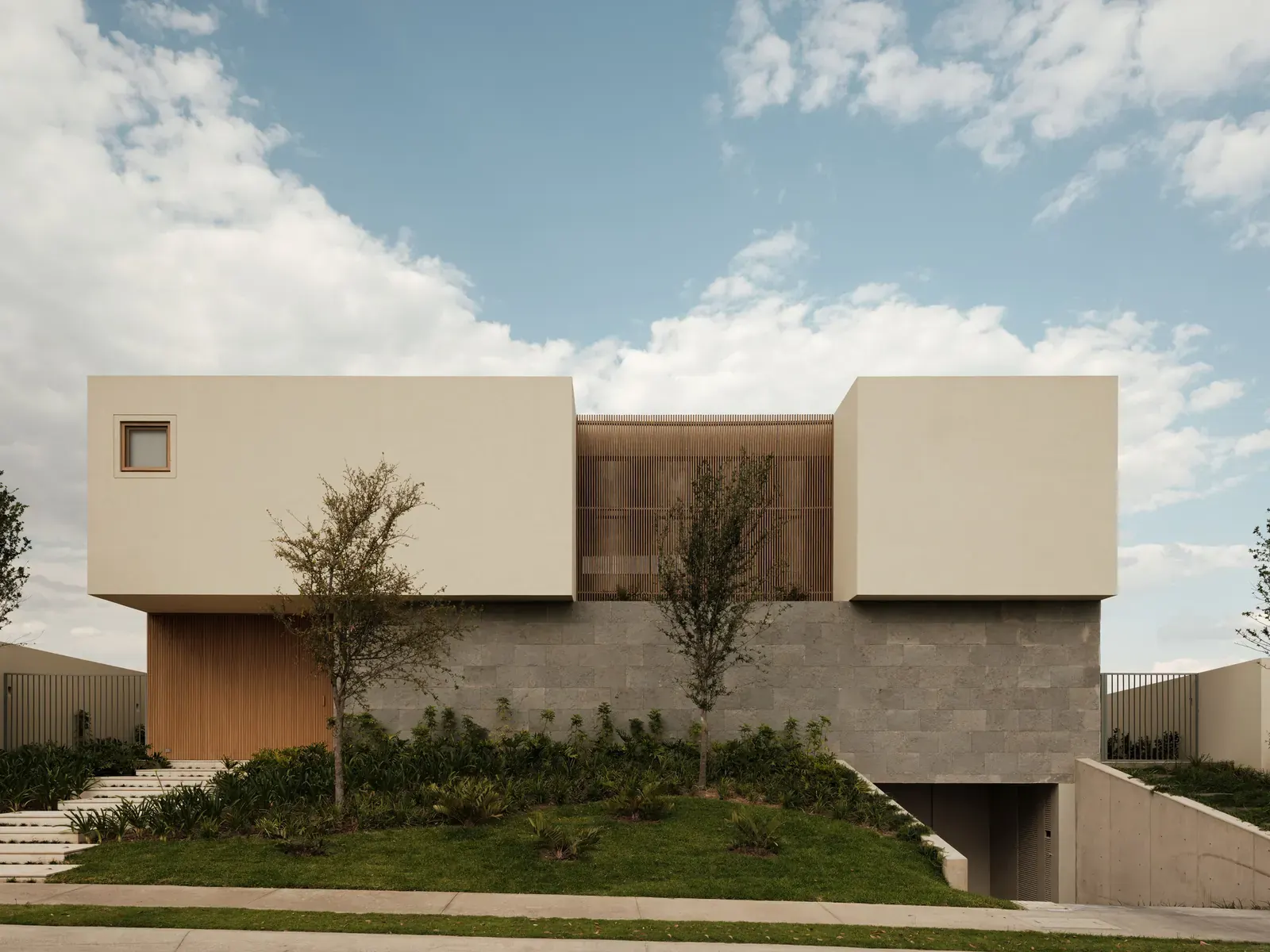 PR House by 0studio Arquitectura features a central courtyard that unifies the home's various spaces and enhances natural light and ventilation.