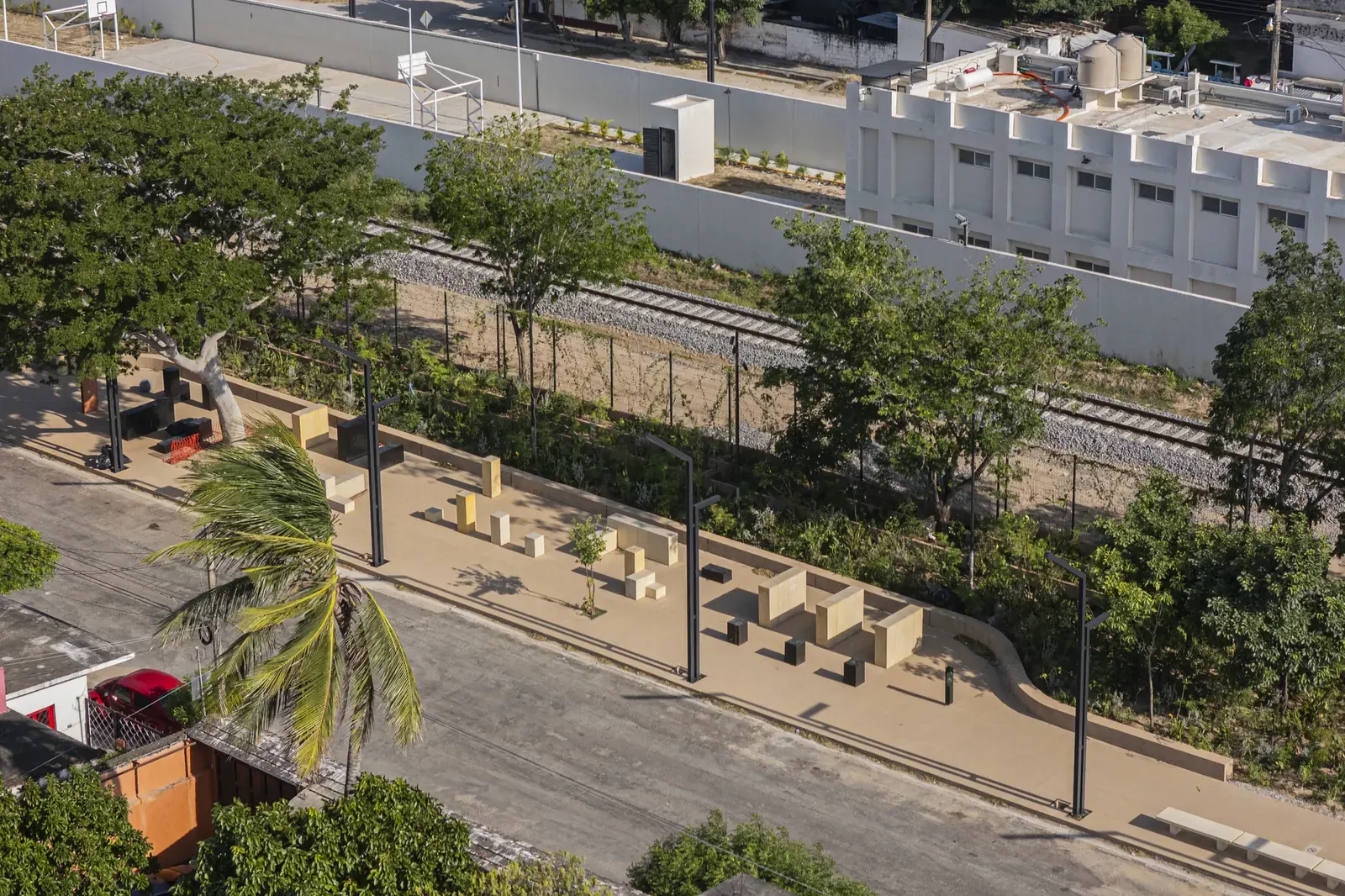 Aerial view of Arriaga Linear Park, highlighting its integration of green spaces and pathways with the adjacent railway infrastructure.