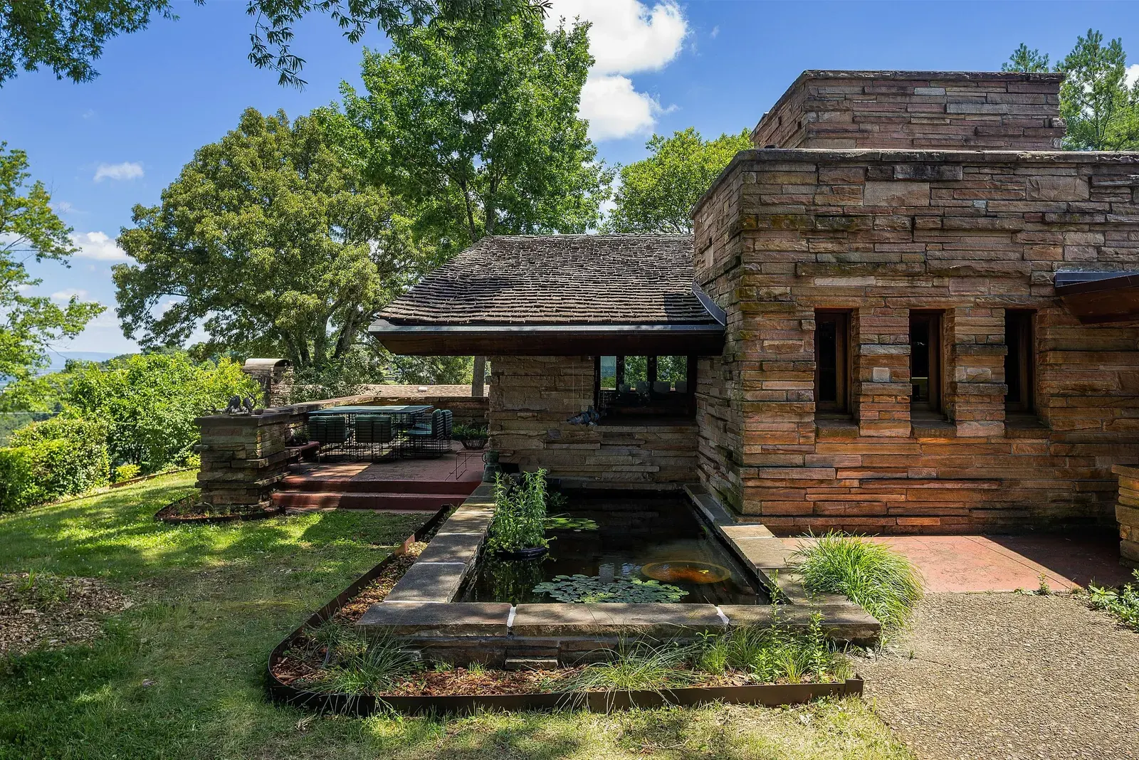 Exterior view of the Shavin House, a Frank Lloyd Wright design in Chattanooga, Tennessee, showcasing its stone and cypress construction.