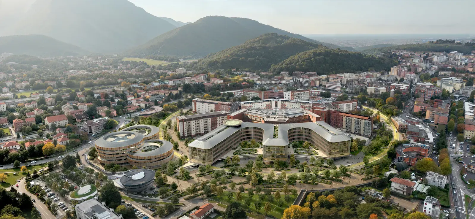 Architectural rendering of a modern hospital complex with green spaces and public areas.
