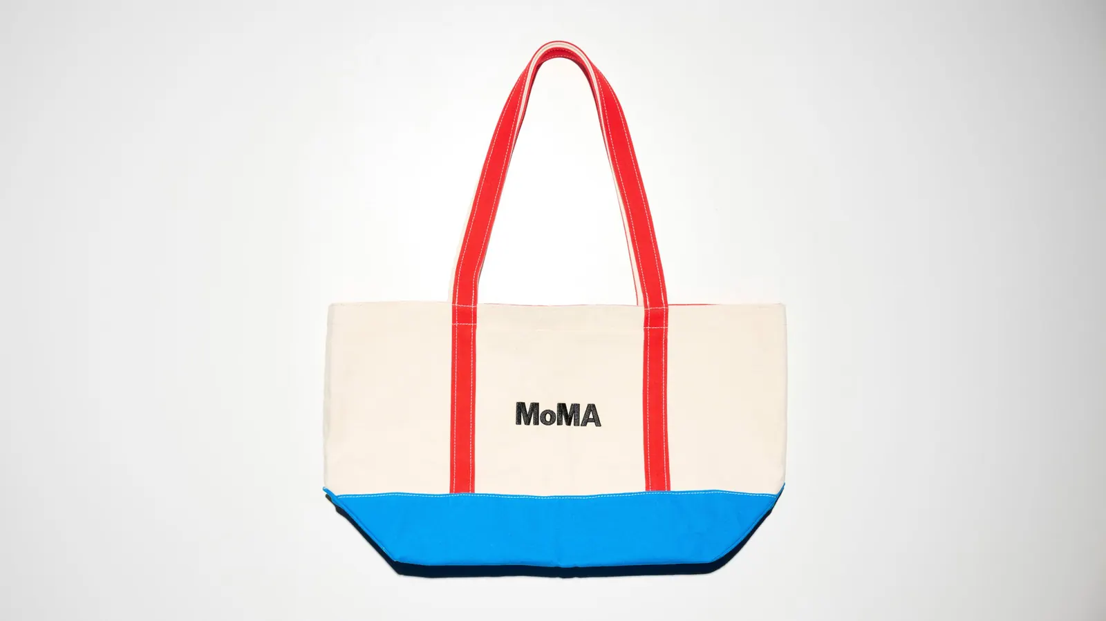 A clear view of the iconic MoMA logo designed by Ivan Chermayeff, featuring bold typography.