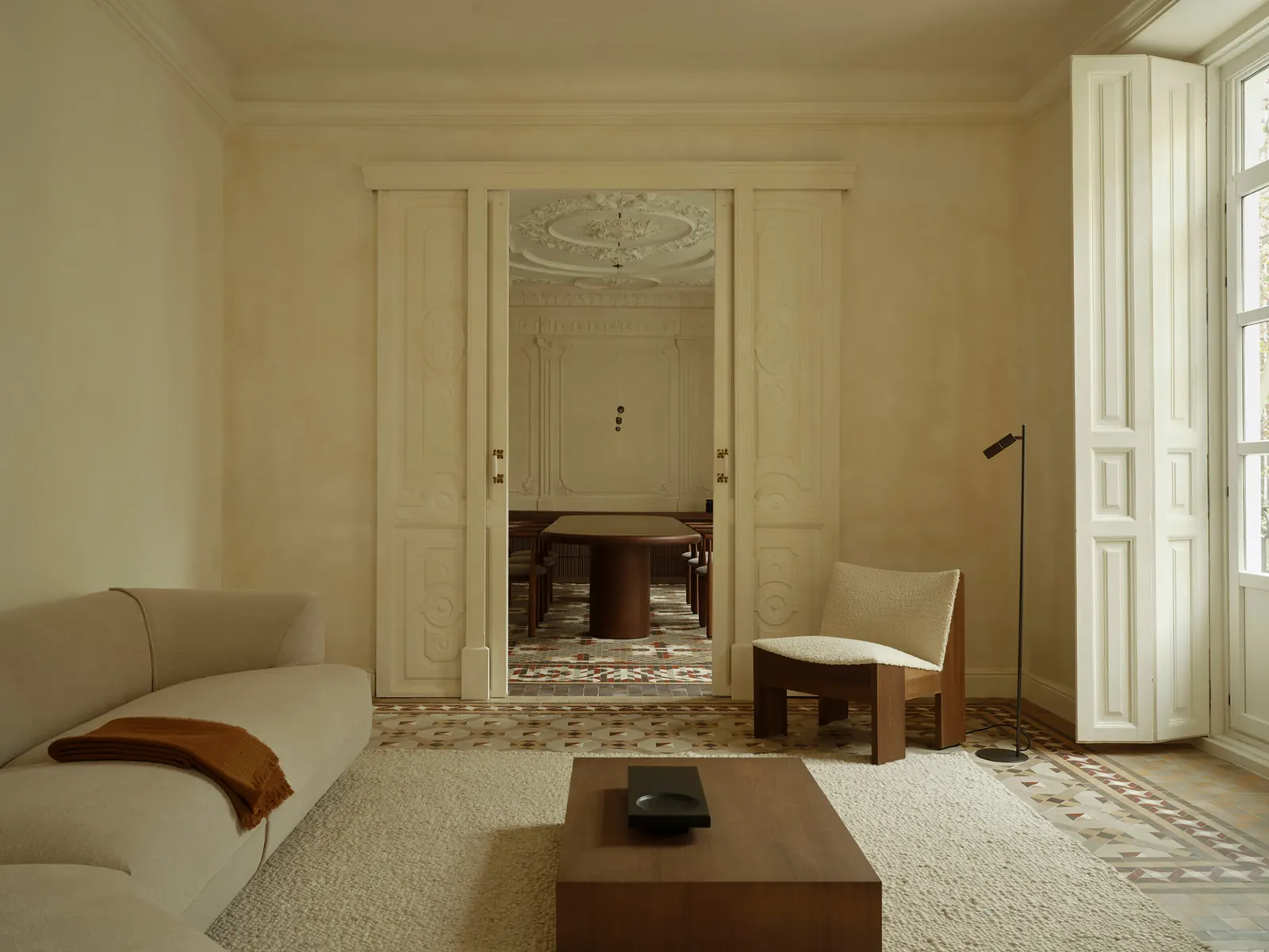 Interior of a renovated apartment in Valencia, Spain, featuring exposed historical architectural details and contemporary furniture.