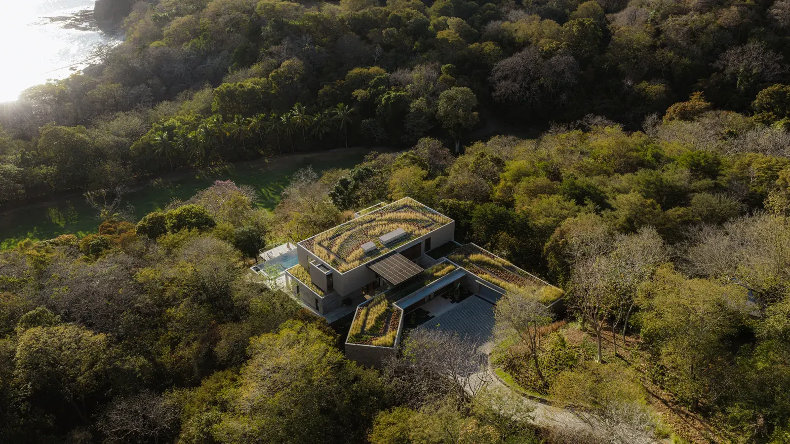 Exterior view of Casa Continuum, a residence integrated into a steep tropical hillside.