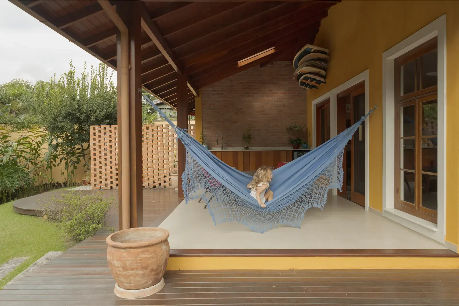 Interior view of the renovated Jardim House, showcasing abundant natural light and views of the surrounding Atlantic Forest.