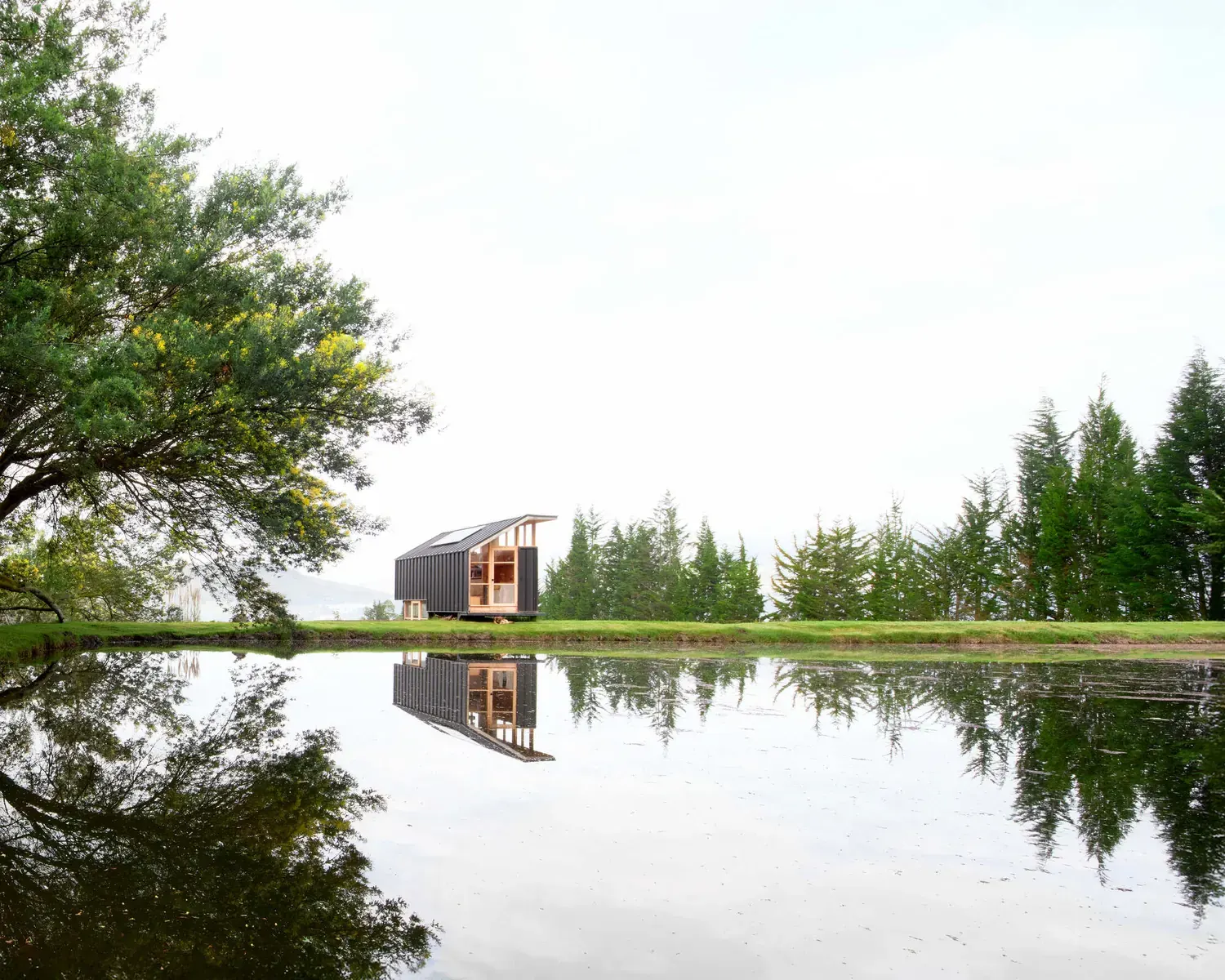 Pukará House, a modern residence with traditional elements, situated in a rural landscape near the Cayambe volcano.