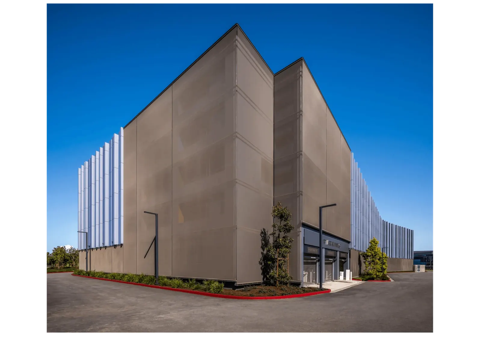 A building facade featuring Fabricoil coiled wire mesh panels for screening.