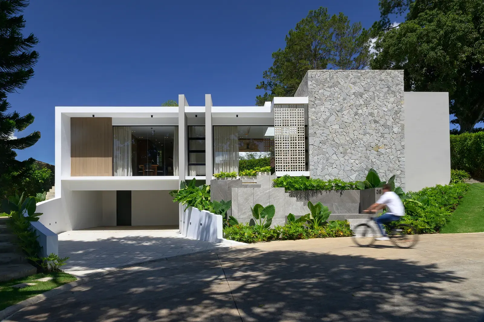 Exterior view of L.A. House, a contemporary residence surrounded by dense vegetation and natural terrain in Jarabacoa, Dominican Republic.