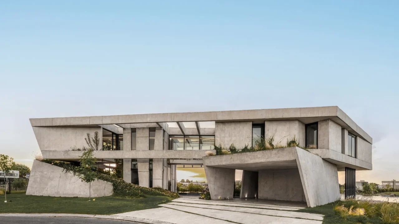 Lomadas House by Grizzo Studio: A Folded Concrete Bar on a Lagoon Shoreline