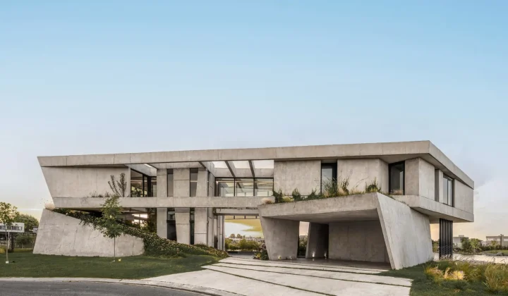 Lomadas House by Grizzo Studio: A Folded Concrete Bar on a Lagoon Shoreline