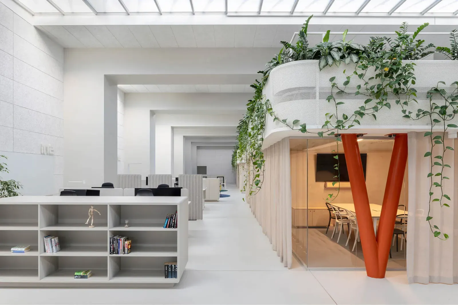 Interior view of the Halcom Offices designed by KIP arhitekti, showcasing a blend of historic industrial elements and modern office furnishings.