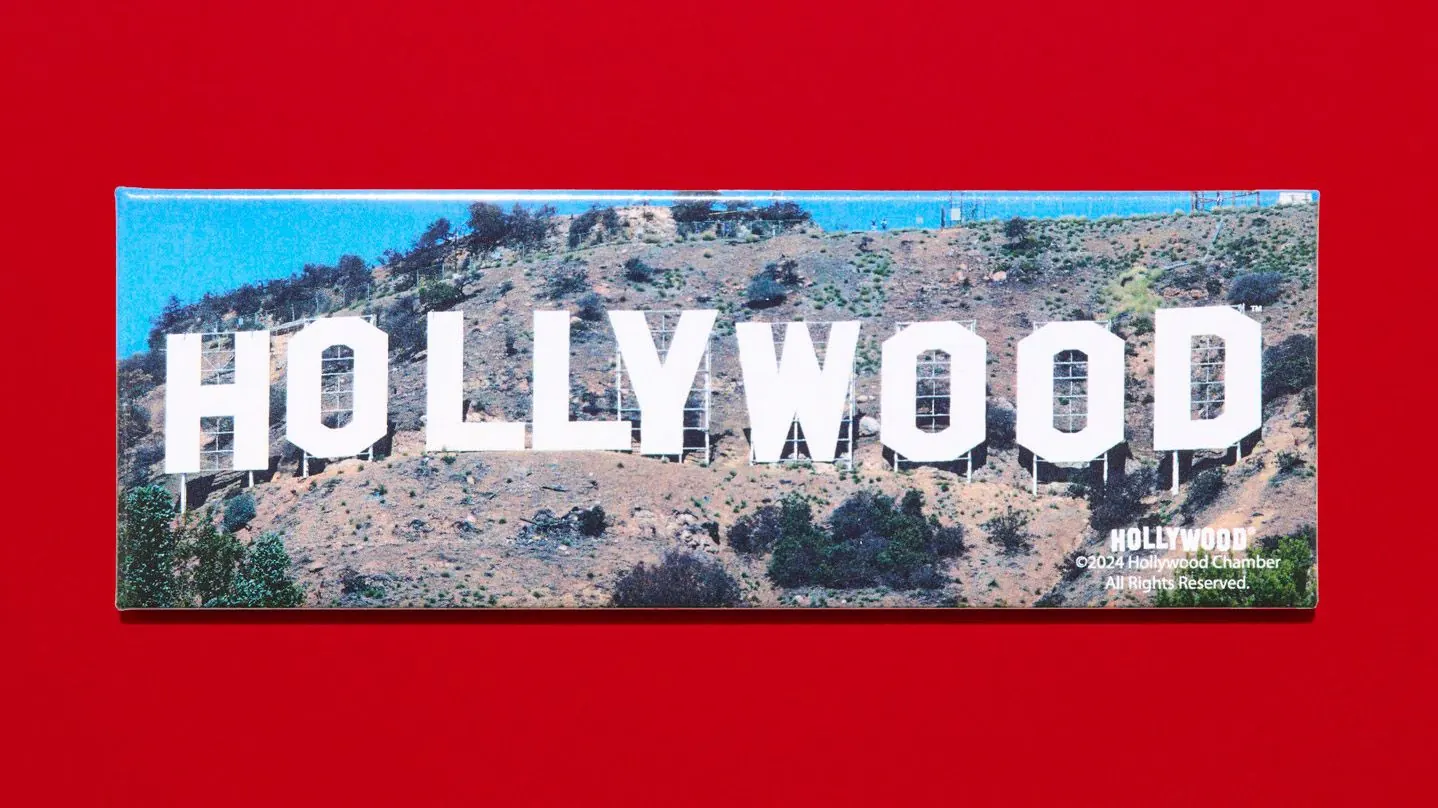 The iconic Hollywood sign illuminated against a twilight sky.
