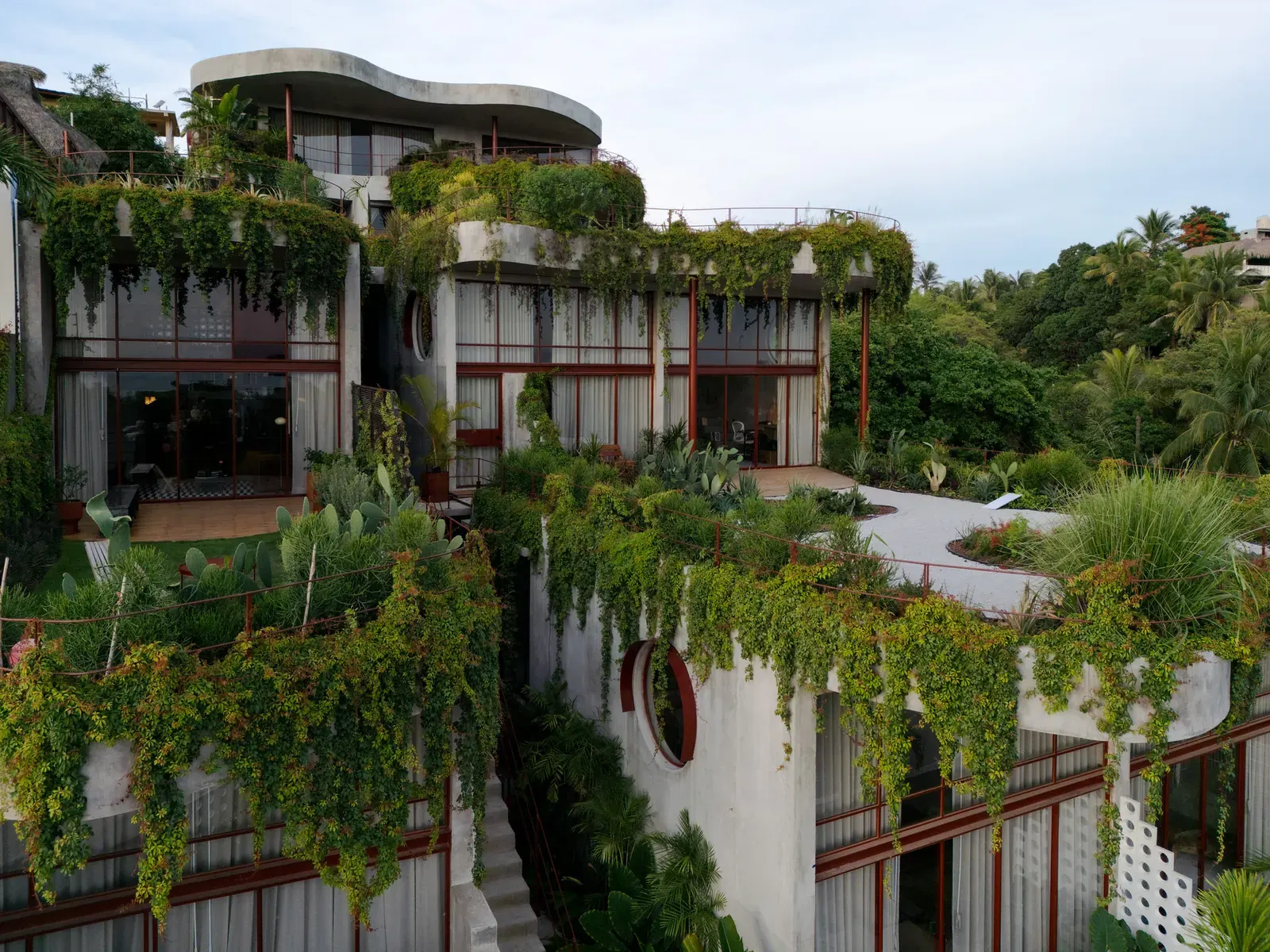 La Pecera Studios building exterior with surrounding lush vegetation, Puerto Escondido, Mexico