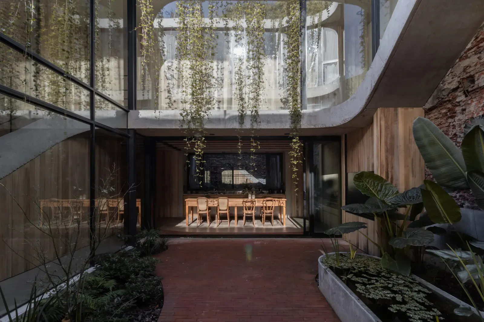 Exterior view of Rivera Paradise House showcasing a facade that blends preserved brick elements with contemporary architectural forms.
