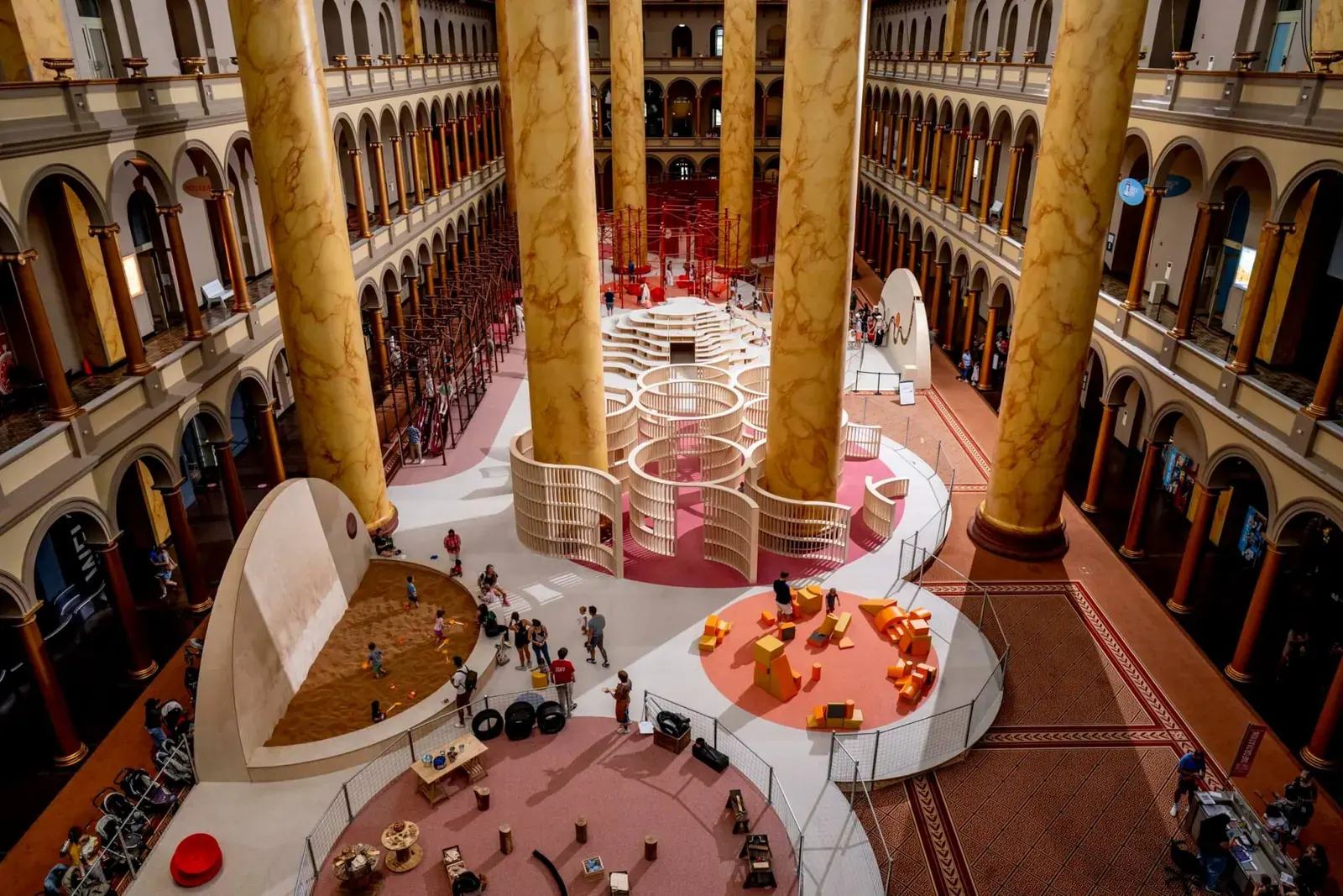 Visitors interacting within Snarkitecture's "THE PLAYGROUND" installation at the National Building Museum's Great Hall.