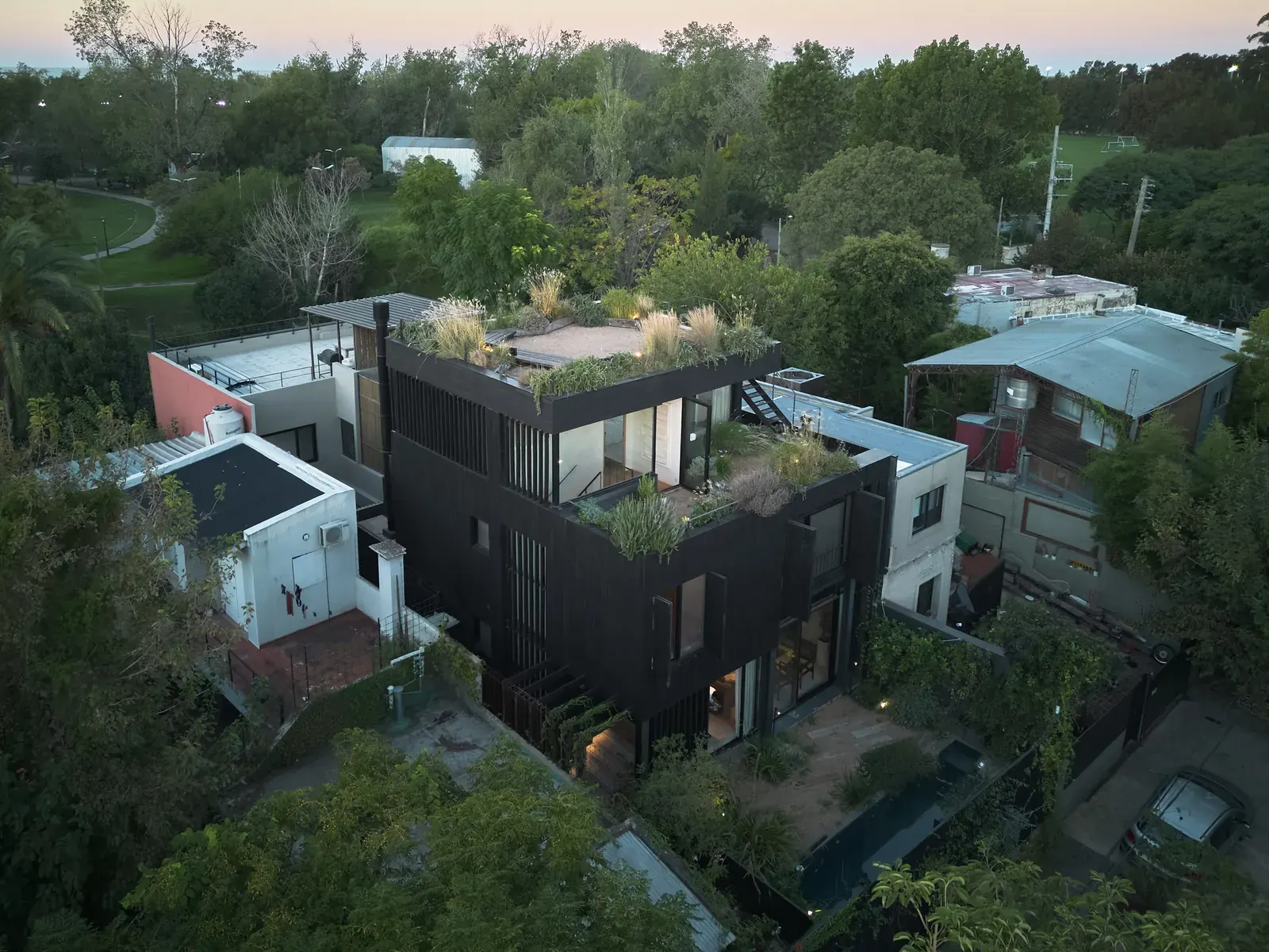 Exterior view of the House in San Isidro, showcasing its integration with the surrounding landscape.