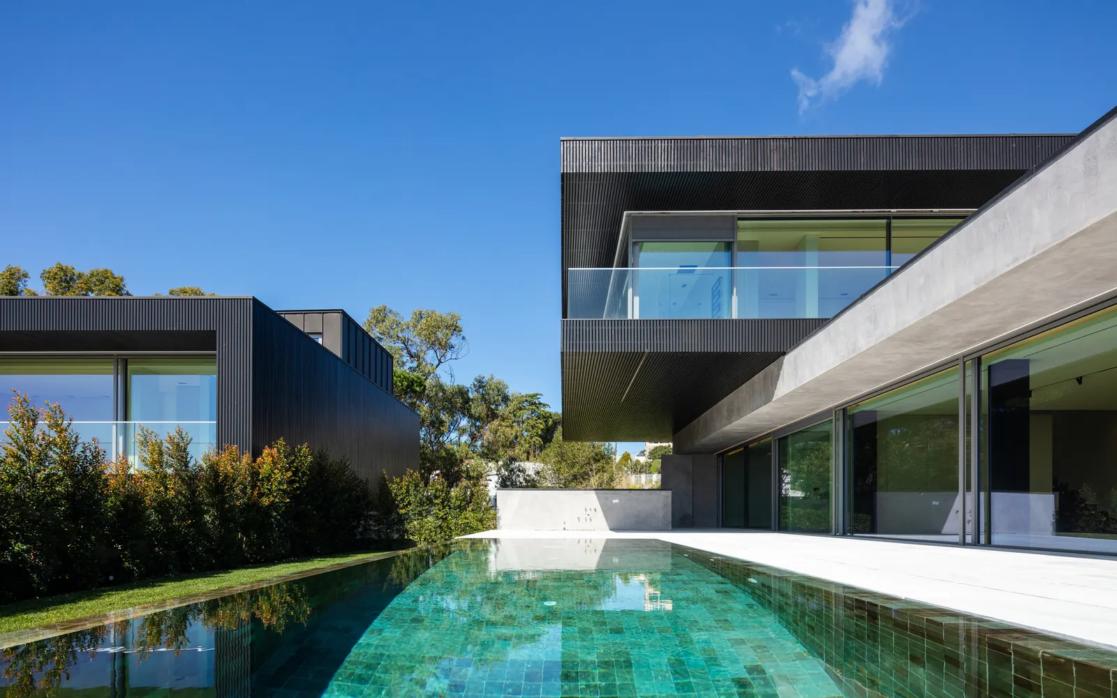 Exterior view of the Condominium 4 Houses in Cascais, showcasing its staggered architectural layout and integration with the landscape.