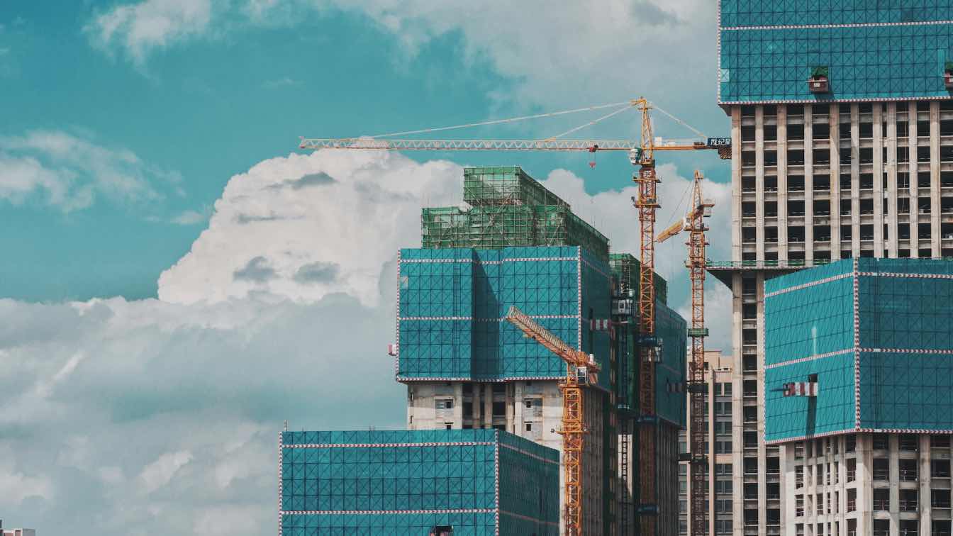 Construction site with drones, LiDAR scanners, and 360 cameras in operation, symbolizing advanced reality capture technology.