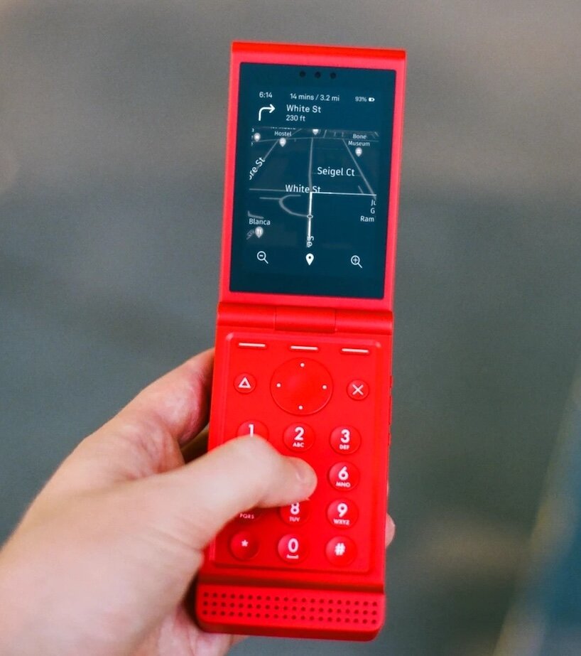 A Light Phone Flip in a clamshell design, shown open to reveal its screen and physical keypad.