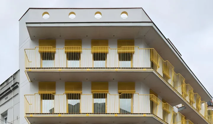 Yellow Steel and Circular Openings Revitalize Spanish Corner Building into Apart-Hotel