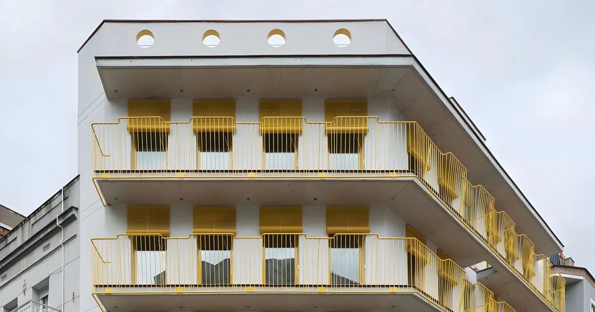 Yellow Steel and Circular Openings Revitalize Spanish Corner Building into Apart-Hotel
