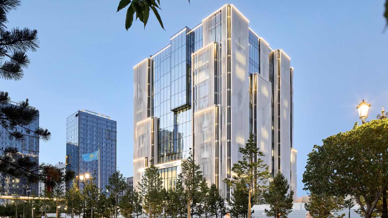 Exterior view of the National Bank of the Republic of Kazakhstan headquarters, a cubic structure with undulating limestone louvres, designed by Zaha Hadid Architects.