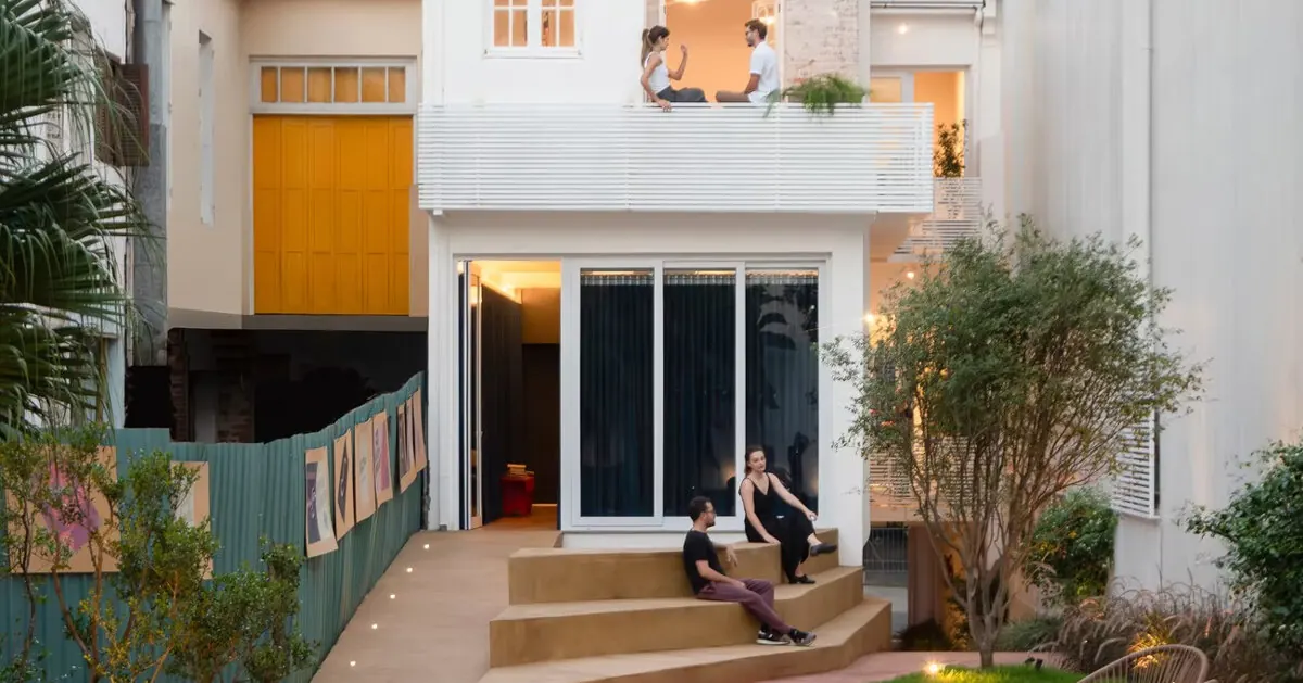 Brazilian House Reimagined as Cultural Art Hub with Exposed Brick and Blue Metal Accents