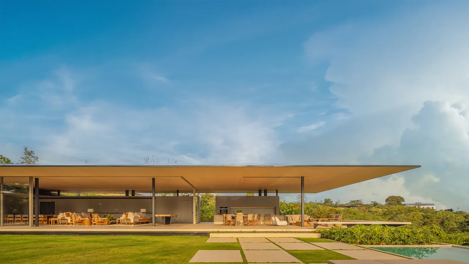 Exterior view of the DRP House, showcasing its cantilevered roof and integration with the São Paulo landscape.